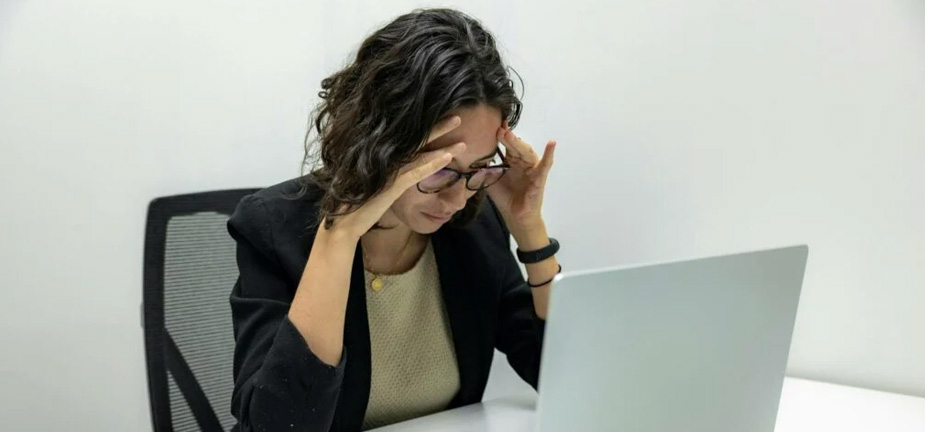 A generic image of a frustrated woman in front of her laptop. Photo: Unsplash